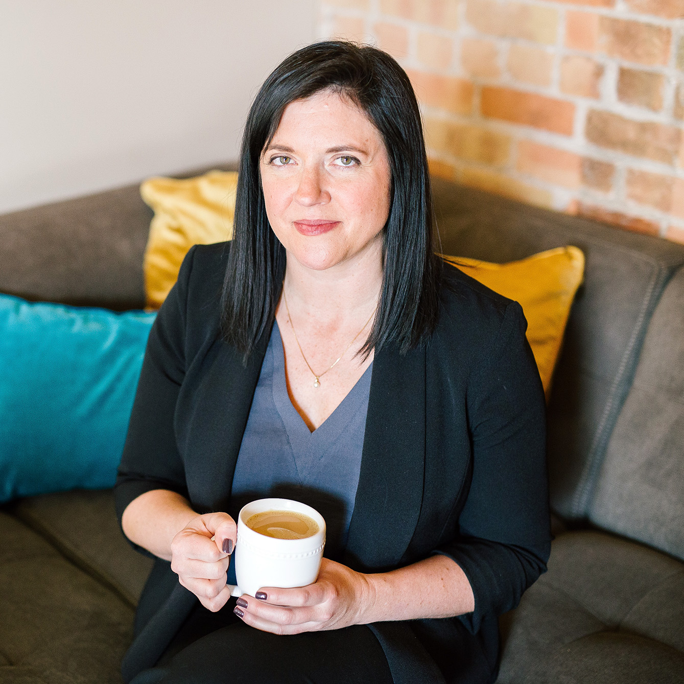 woman small business owner holding coffee mug